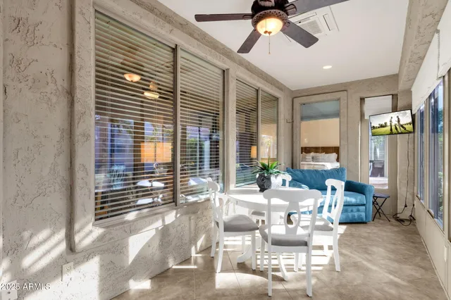a living room with furniture and floor to ceiling windows