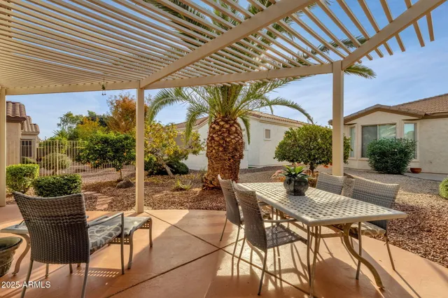a view of a patio with table and chairs and potted plants