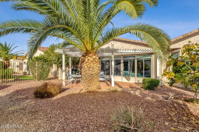 a front view of a house with a garden