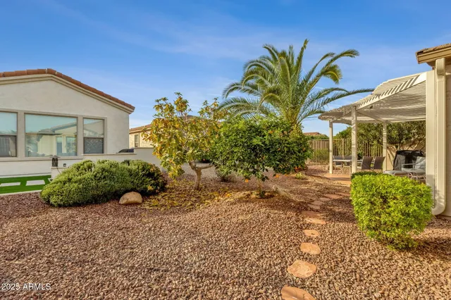 a front view of a house with a garden