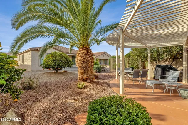 a view of a patio with table and chairs and potted plants