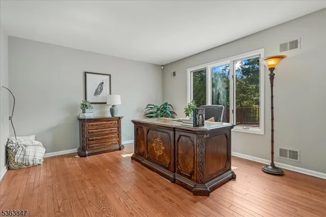 a kitchen with stainless steel appliances granite countertop a stove and a wooden floors