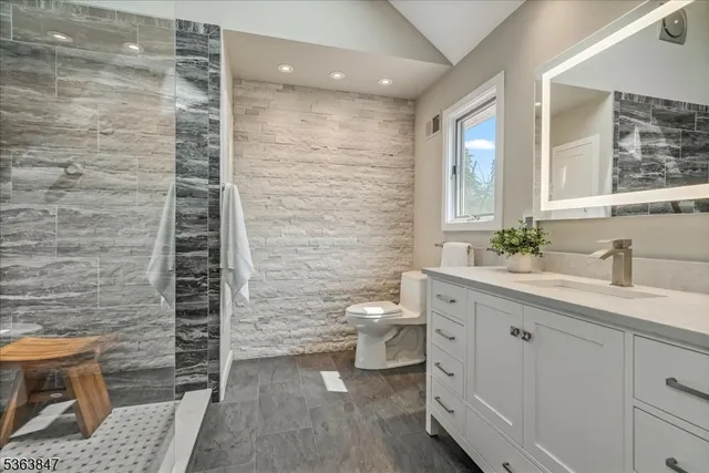 a bathroom with a double vanity sink toilet and shower