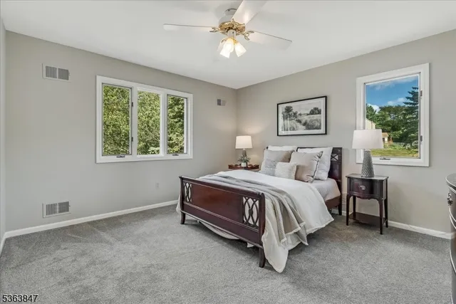 a spacious bedroom with a bed and a window