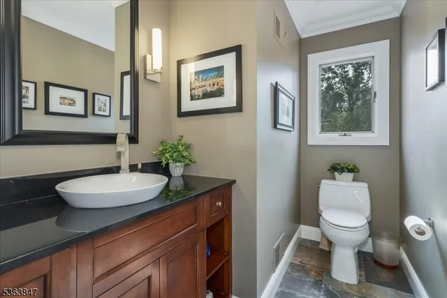 a bathroom with a toilet a sink and a mirror