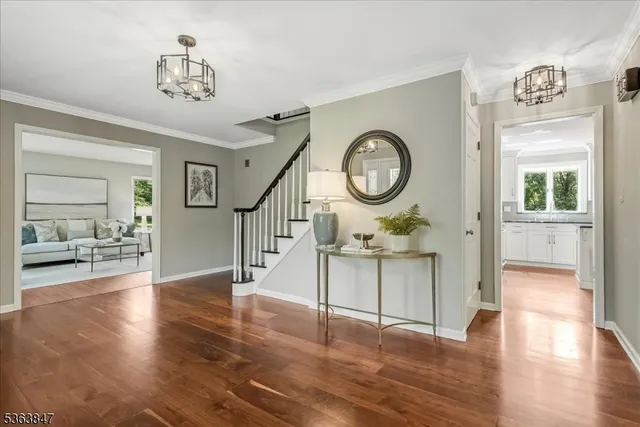 a view of a hallway with wooden floor and furniture