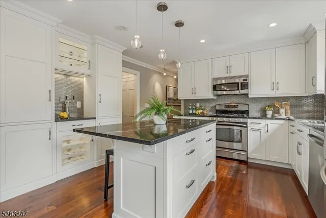 a kitchen with stainless steel appliances granite countertop a sink and cabinets