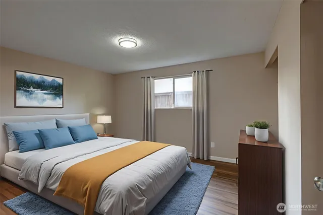 a bedroom with a bed and a painting on the wall