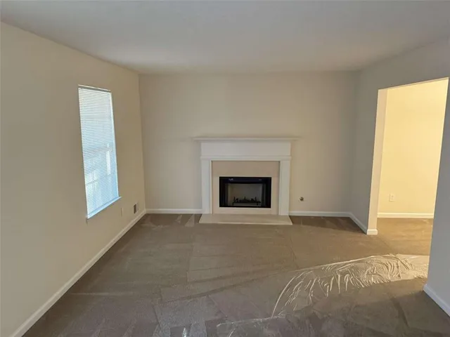 a view of empty room with a fireplace
