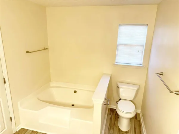 a bathroom with a toilet sink and a mirror