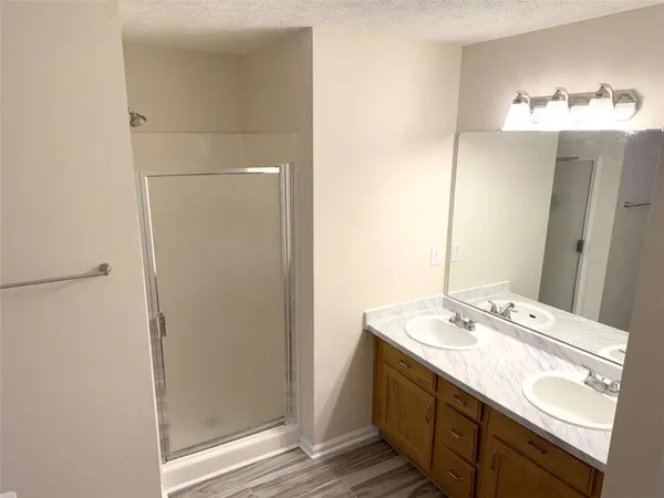 a bathroom with a double vanity sink and a mirror