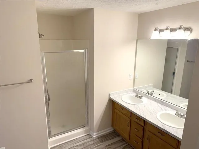 a bathroom with a double vanity sink and a mirror