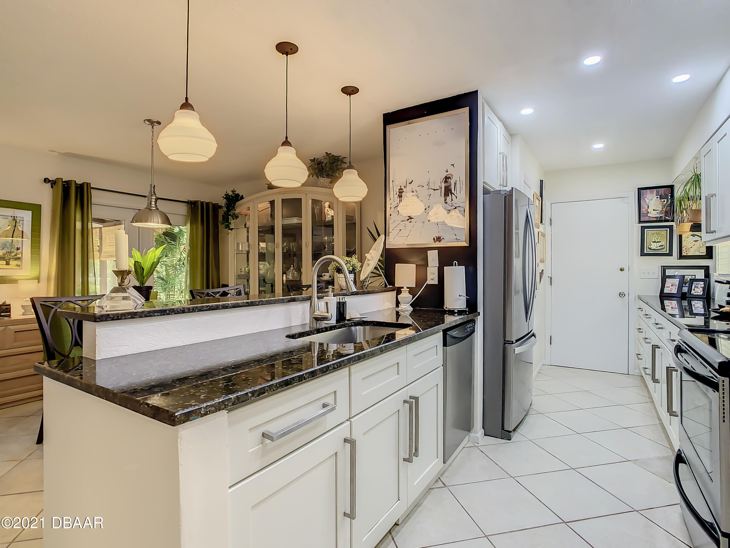 127 Cypress Pond Road Port Orange, FL 32128 - Photo 13 of 52 a kitchen with stainless steel appliances granite countertop a sink a stove and a refrigerator