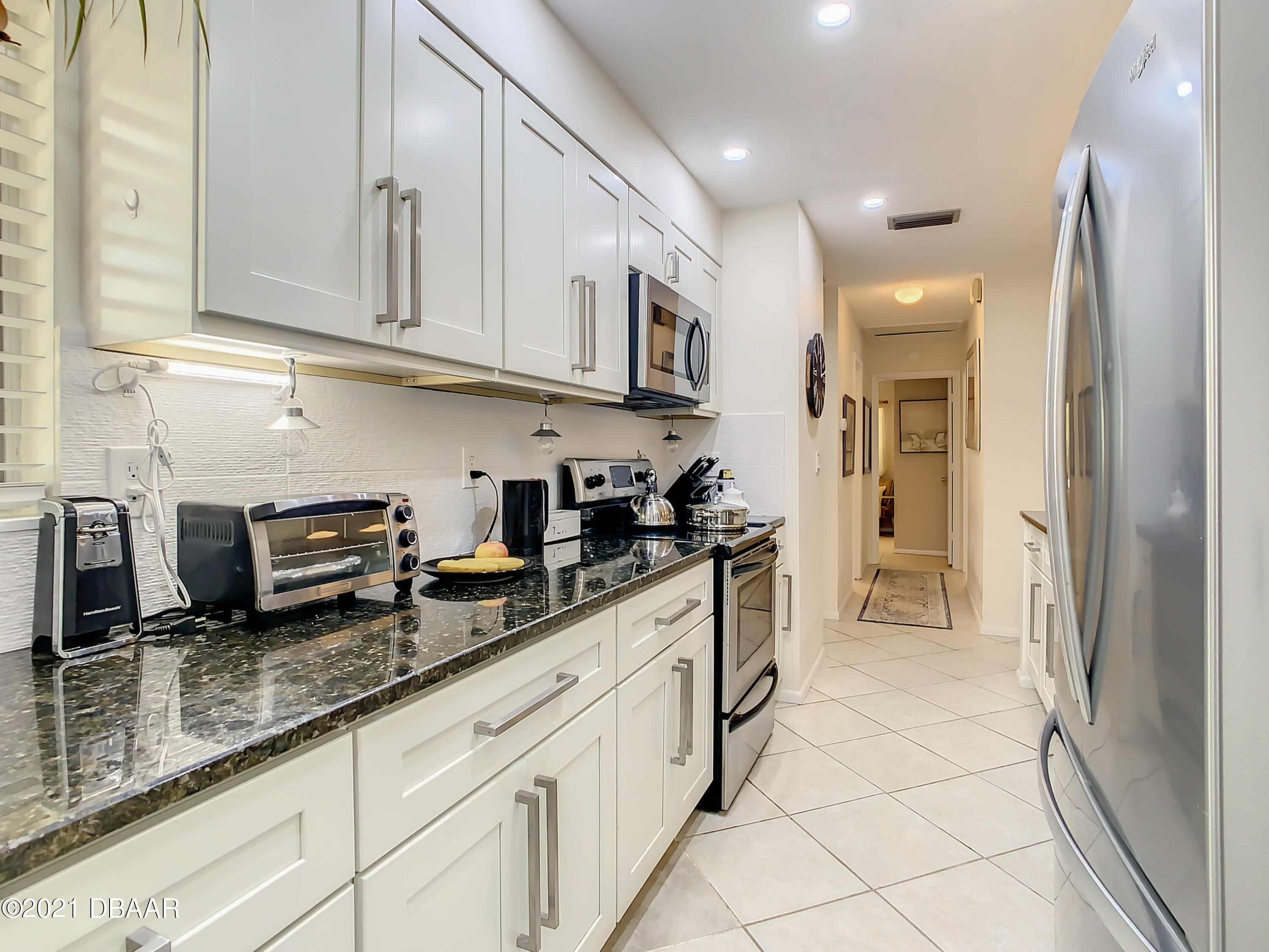 127 Cypress Pond Road Port Orange, FL 32128 - Photo 16 of 52 a kitchen with stainless steel appliances granite countertop a refrigerator and a sink