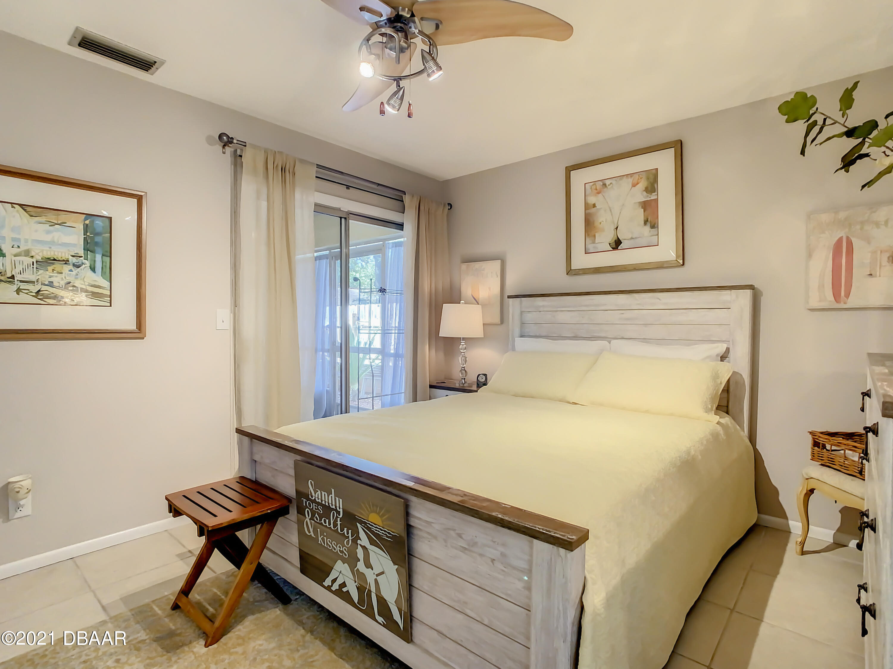 127 Cypress Pond Road Port Orange, FL 32128 - Photo 30 of 52 a bedroom with a bed and a chandelier