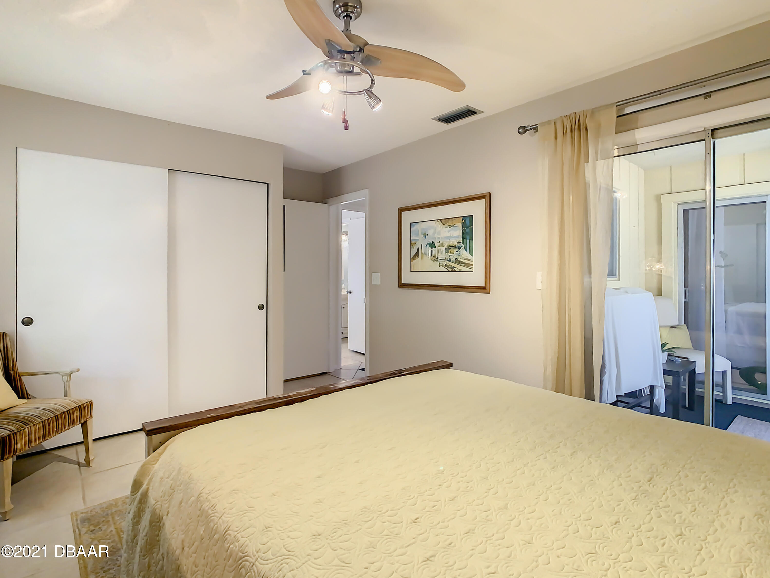 127 Cypress Pond Road Port Orange, FL 32128 - Photo 31 of 52 a bedroom with a bed and a chandelier