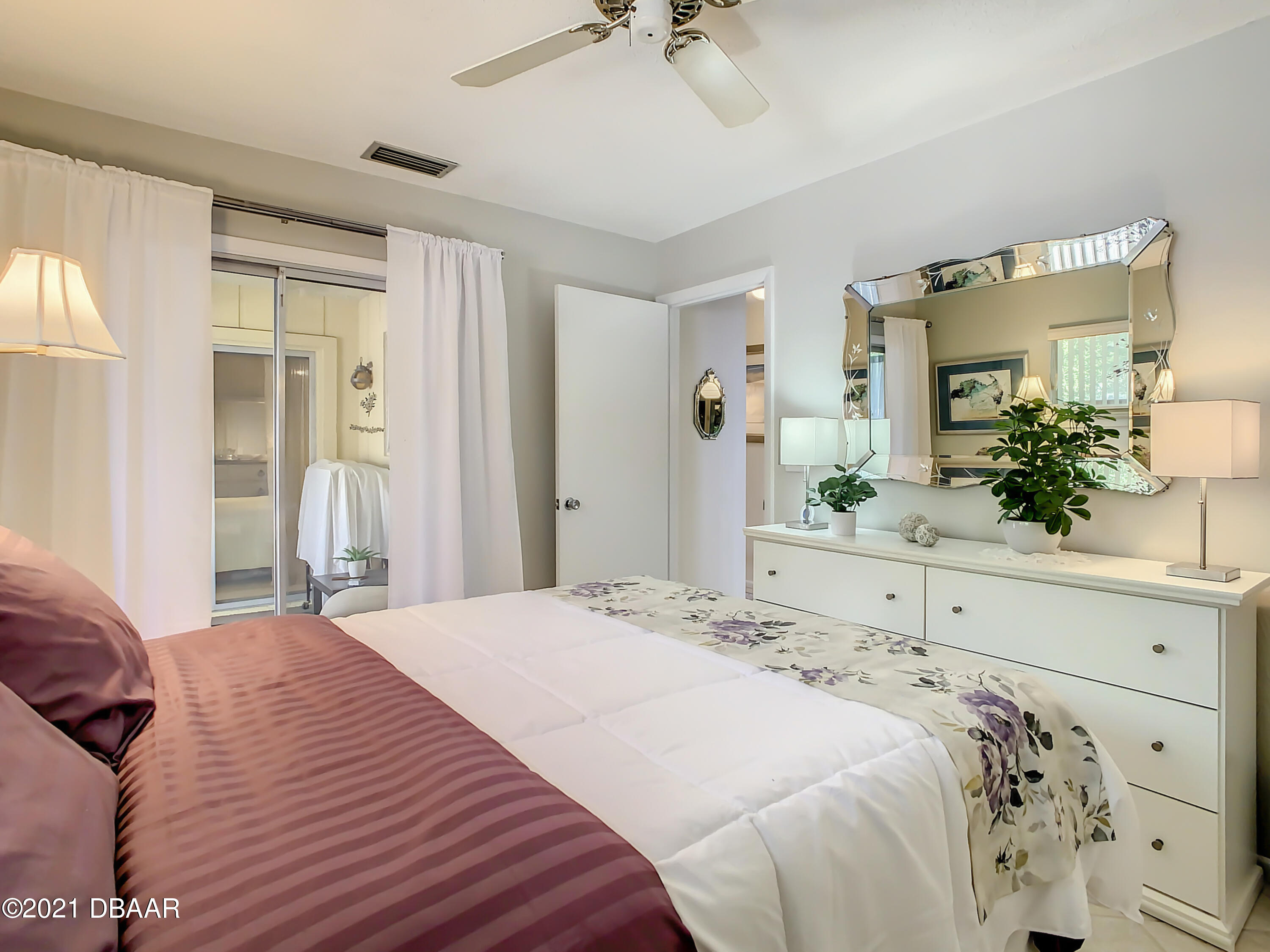 127 Cypress Pond Road Port Orange, FL 32128 - Photo 36 of 52 a bedroom with a large bed and a chandelier