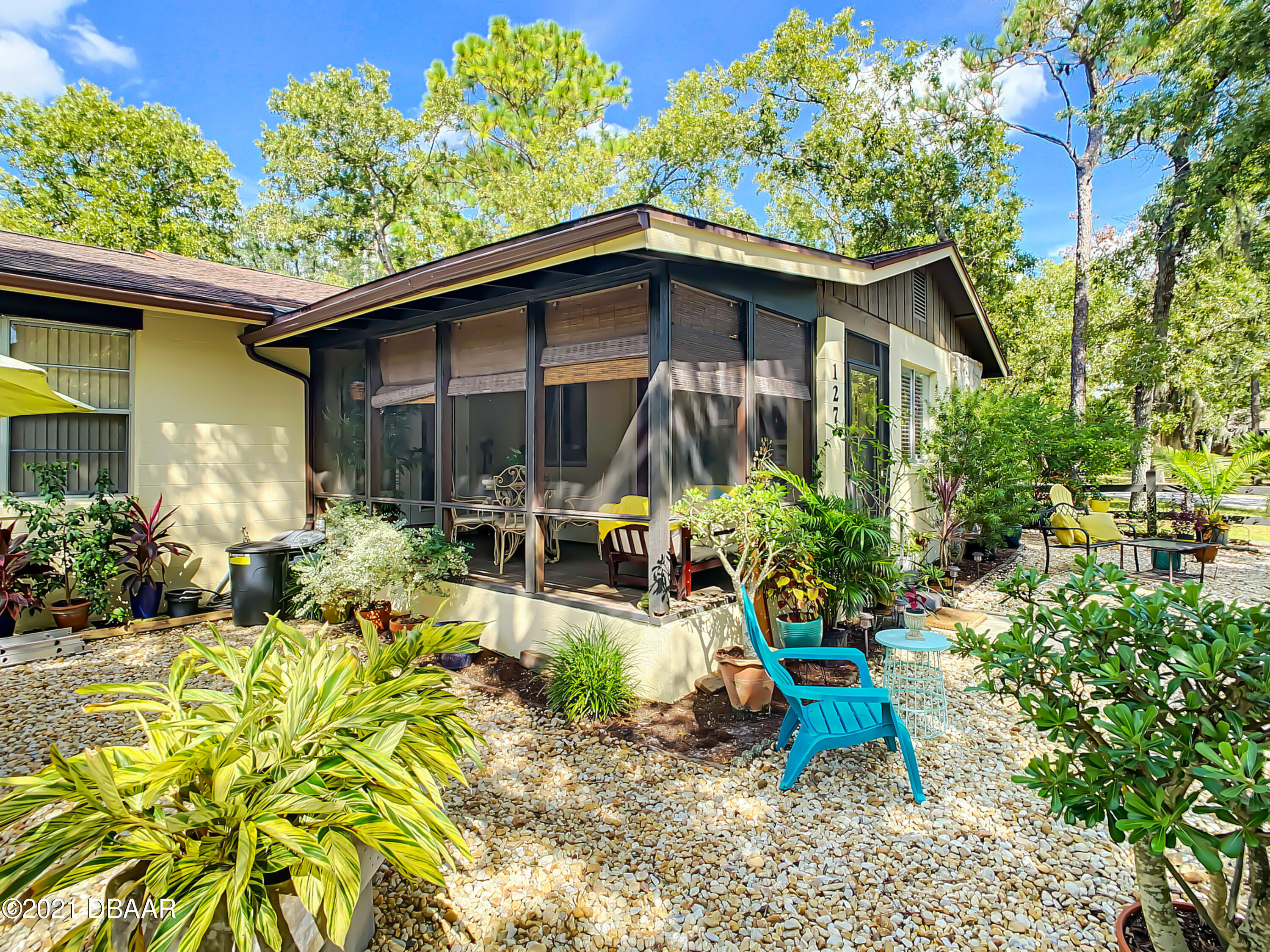 127 Cypress Pond Road Port Orange, FL 32128 - Photo 50 of 52 a view of a chair and table in the patio in front of house