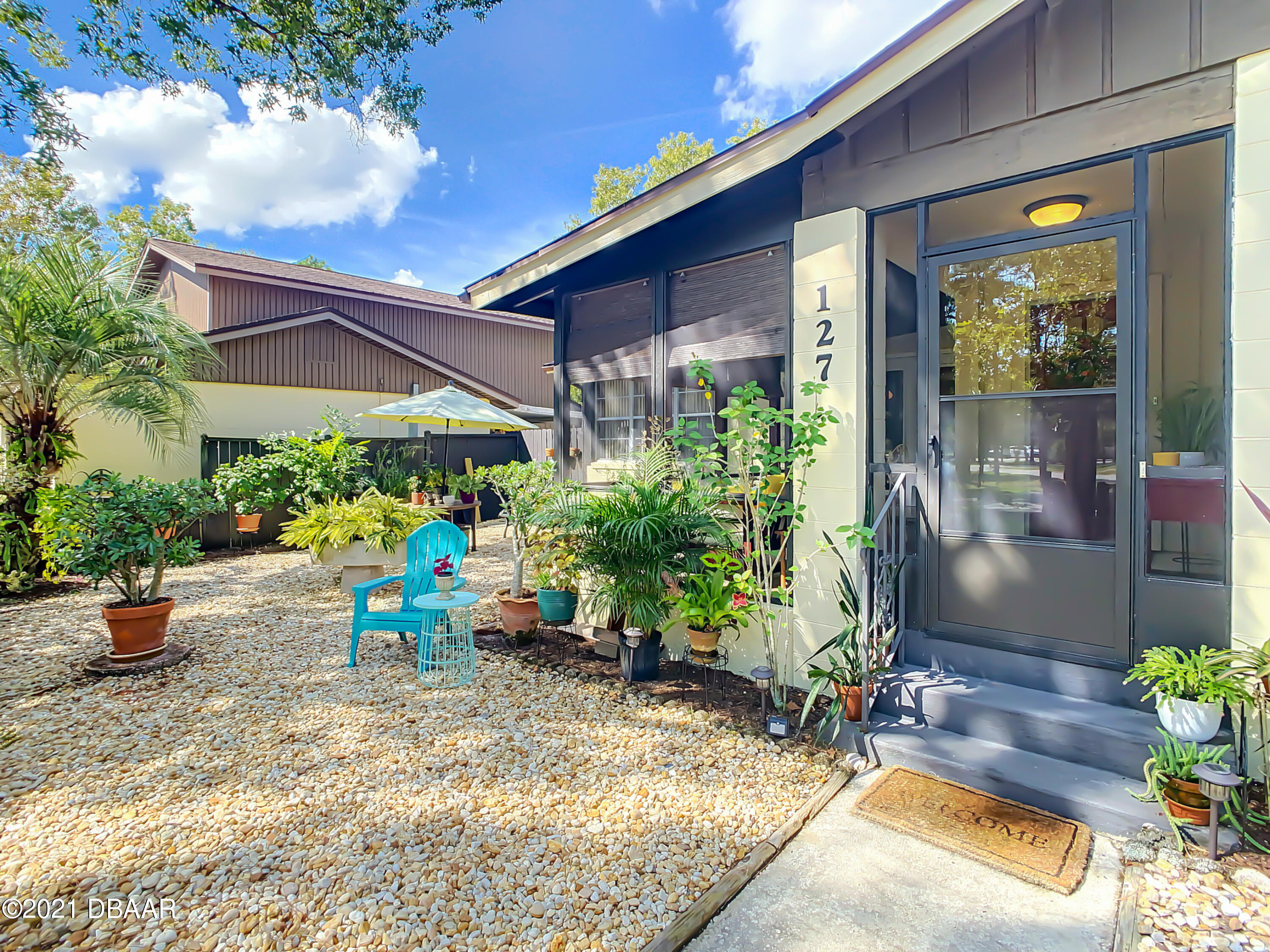 127 Cypress Pond Road Port Orange, FL 32128 - Photo 5 of 52 a view of a chairs and table in a patio