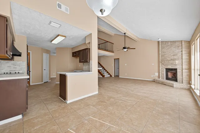 a view of a kitchen with a sink and a fireplace