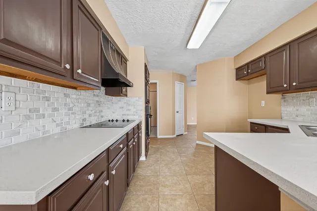 a kitchen with a sink stove and cabinets
