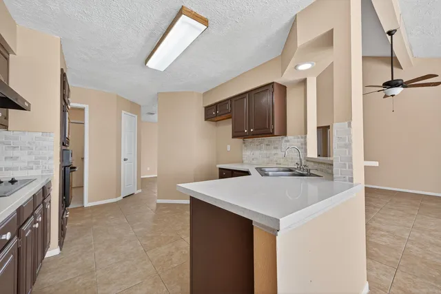 a kitchen with a sink a stove and refrigerator