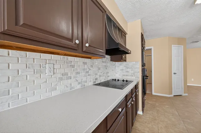 a kitchen with a sink cabinets and stainless steel appliances