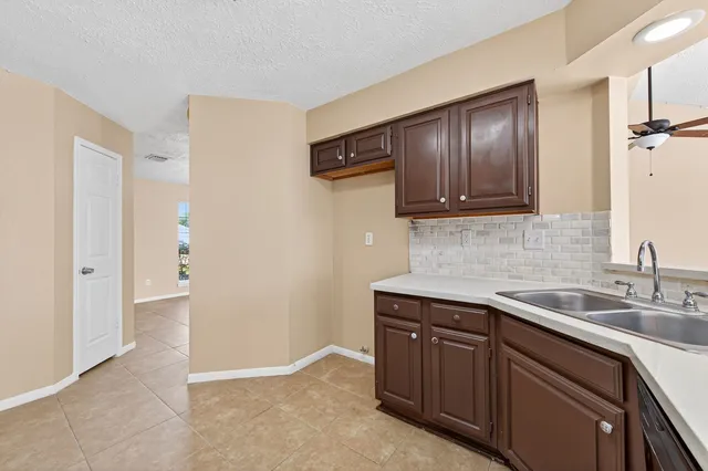 a kitchen with a sink and cabinets