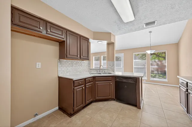a kitchen with a sink and cabinets