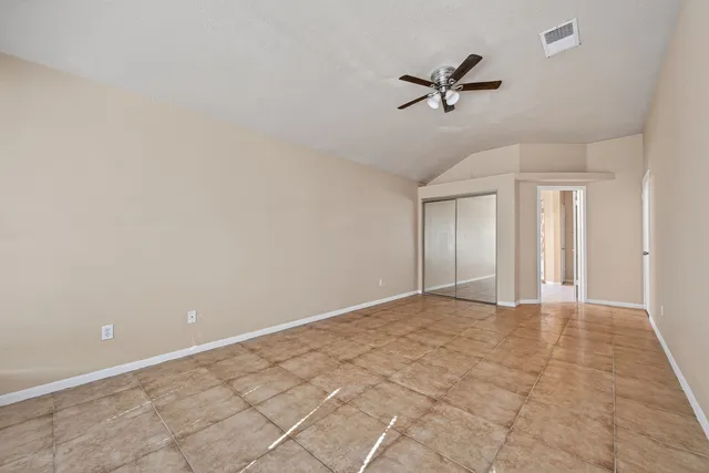 a view of a livingroom with a ceiling fan and window