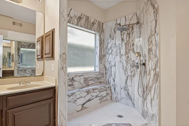 a bathroom with a shower and a sink