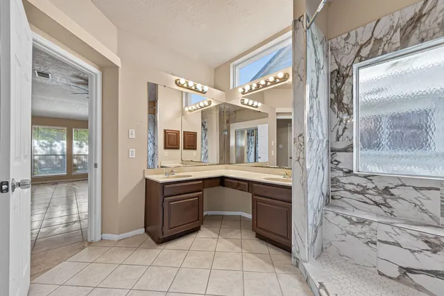 a view of a bathroom with sink and mirror