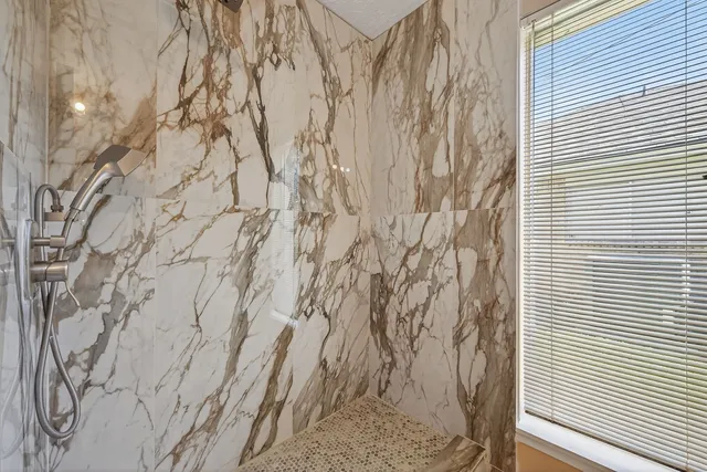 a picture of a white house with a snow on the road