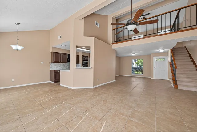 a view of an empty room with a kitchen