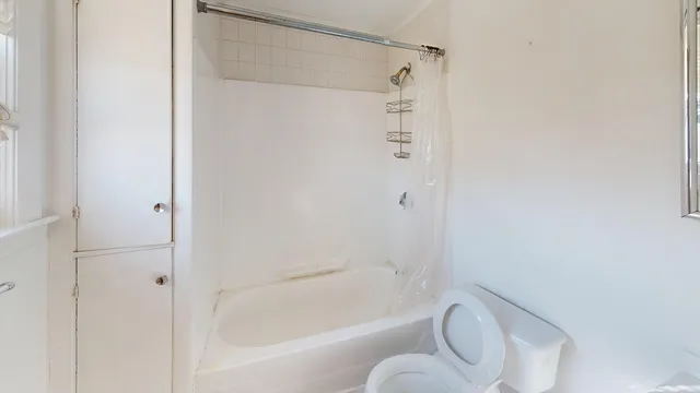 a bathroom with a bathtub and a shower
