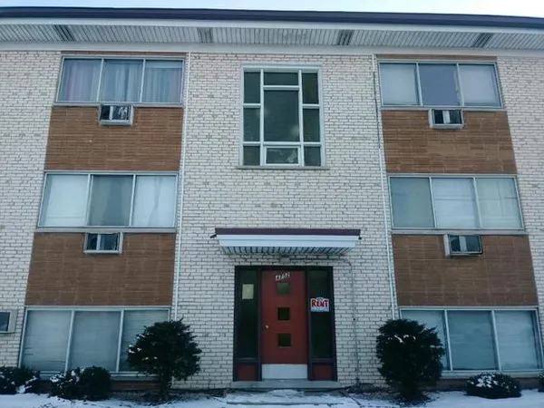 a front view of a house with plants