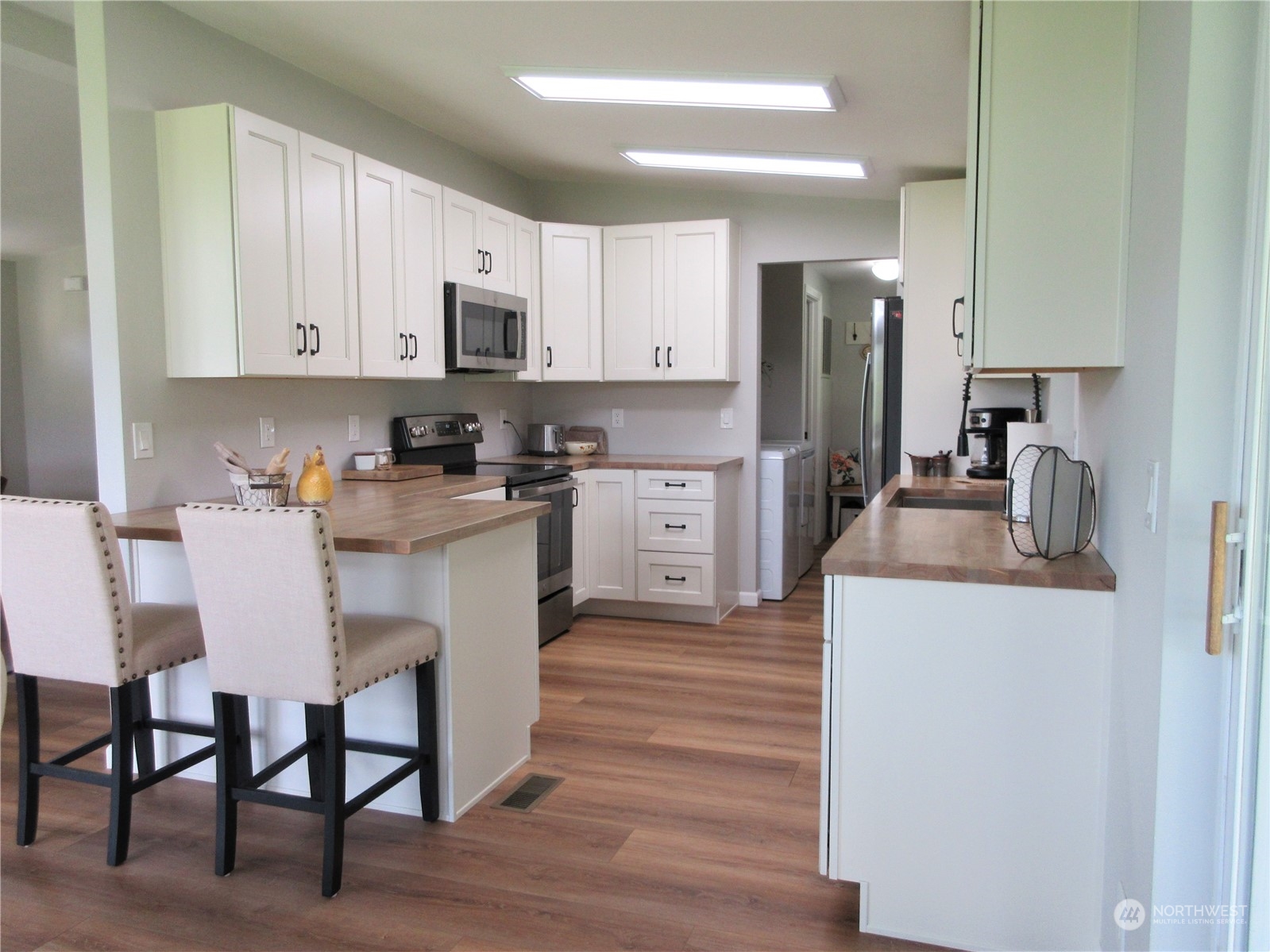 156 West Curlew Lake Road Republic, WA 99166 - Photo 2 of 36 a kitchen with stainless steel appliances granite countertop a table chairs microwave and sink