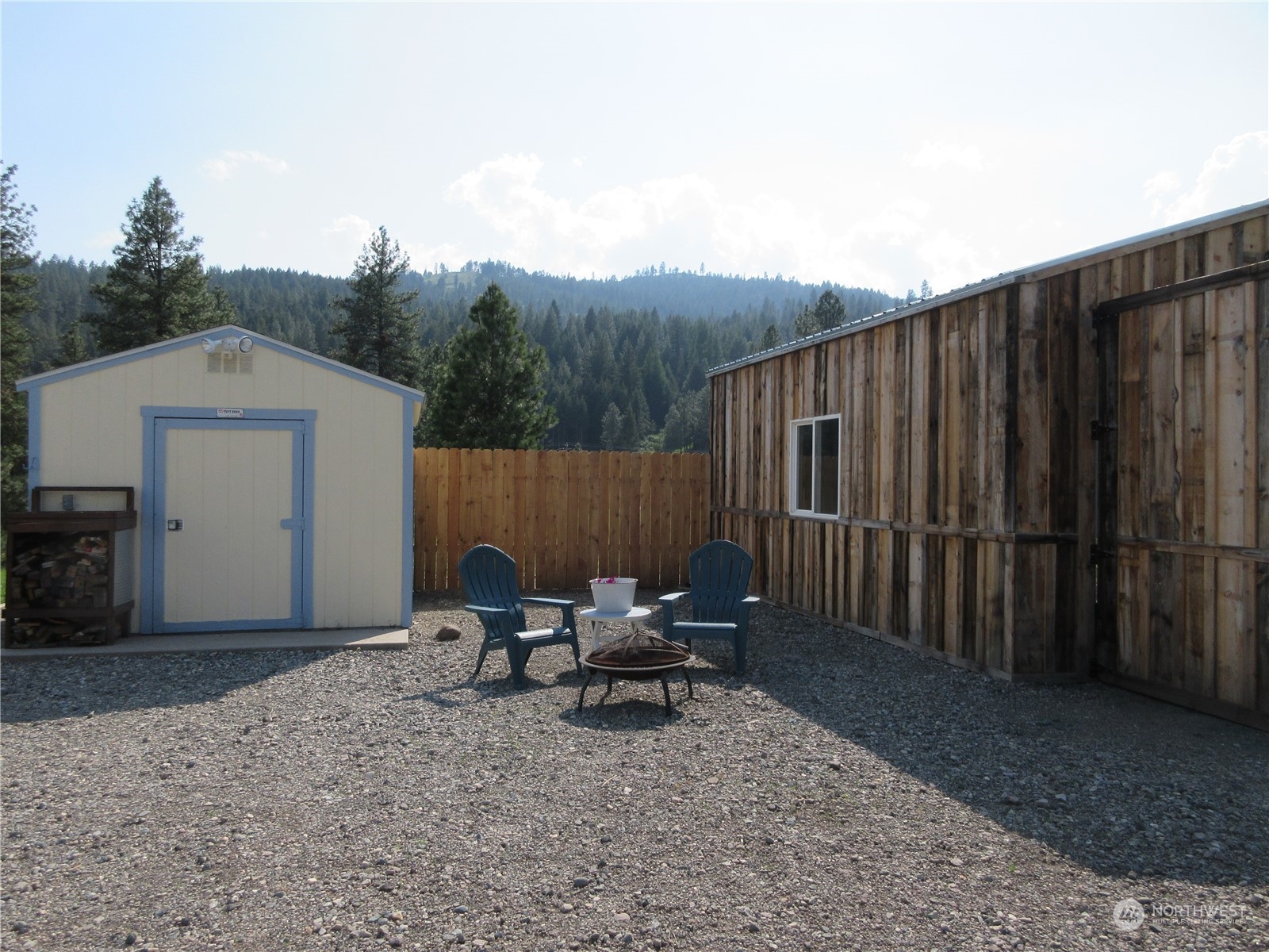 156 West Curlew Lake Road Republic, WA 99166 - Photo 24 of 36 a backyard of a house with table and chairs