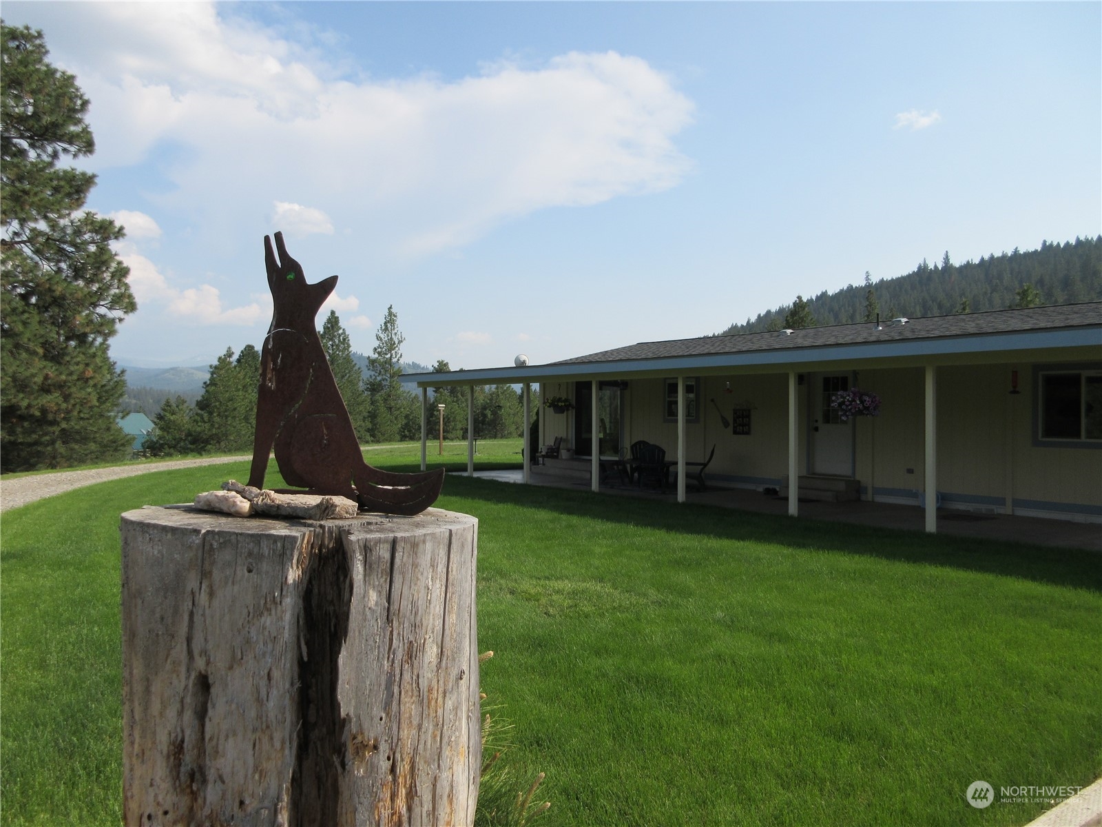 156 West Curlew Lake Road Republic, WA 99166 - Photo 32 of 36 a view of a house with backyard sitting area and garden
