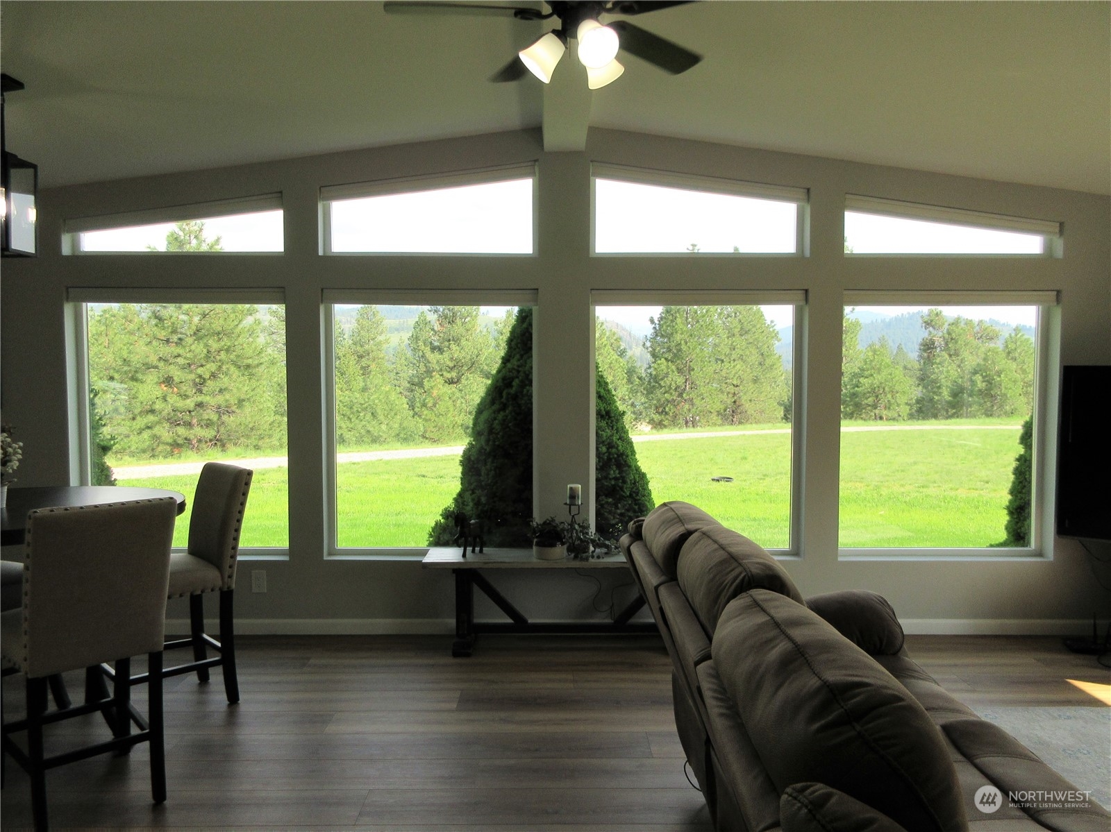 156 West Curlew Lake Road Republic, WA 99166 - Photo 6 of 36 a living room with furniture and floor to ceiling windows