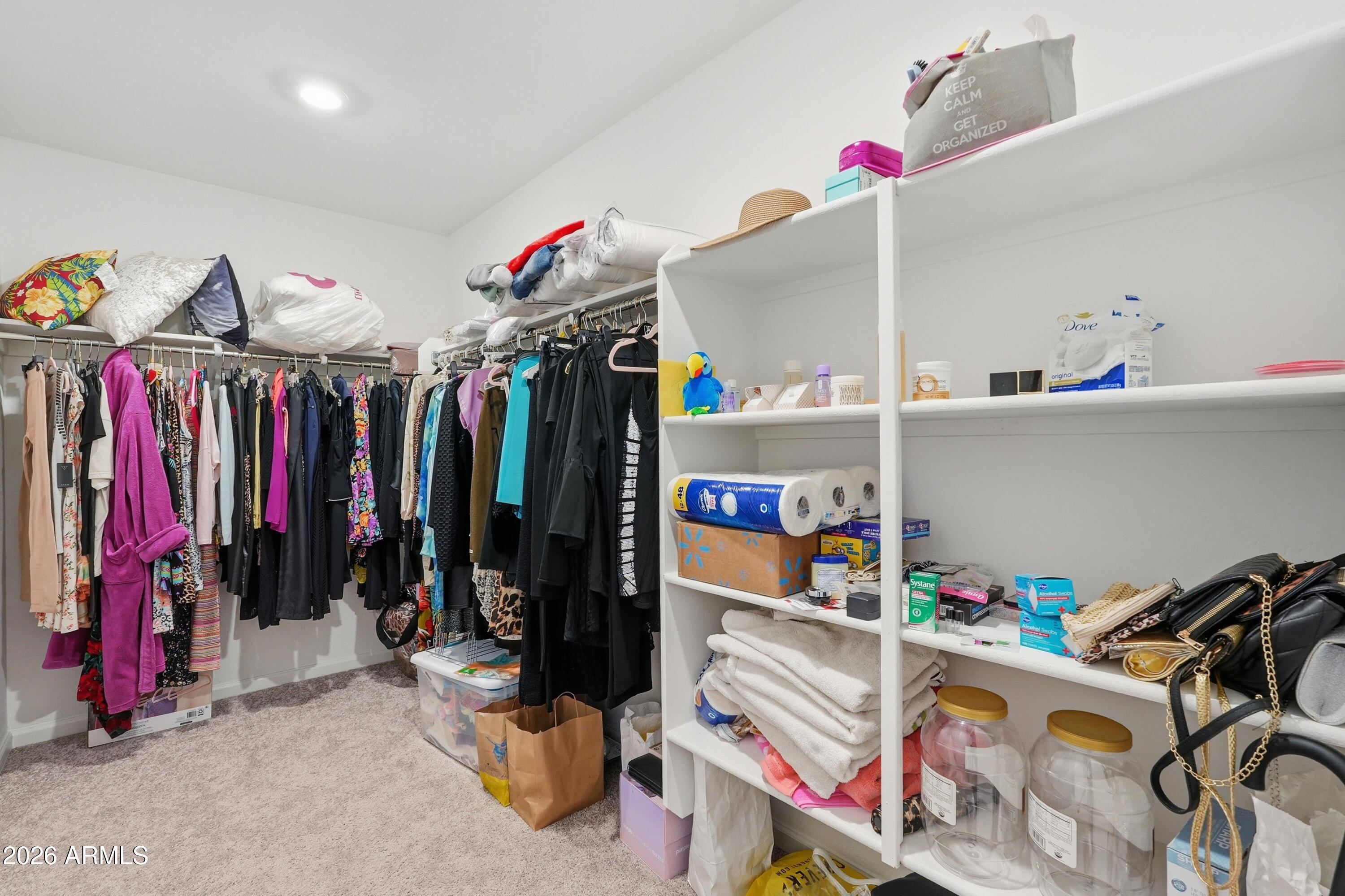 15610 South Moon Valley Road Arizona City, AZ 85123 - Photo 25 of 36 a view of walk in closet with clothes and shoes