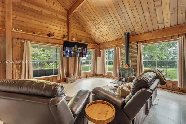 a living room with furniture and large windows