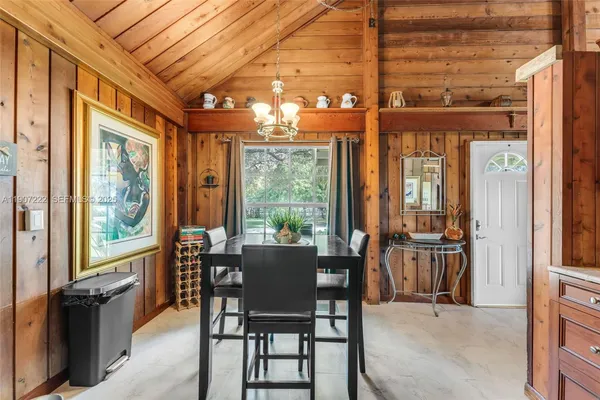 a view of a dining room with furniture large windows and wooden floor
