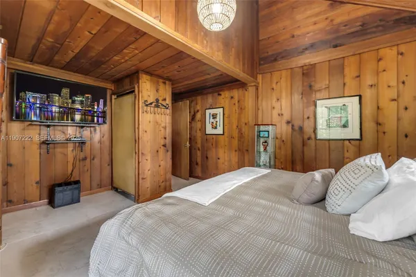 a bedroom with a bed and a book shelf