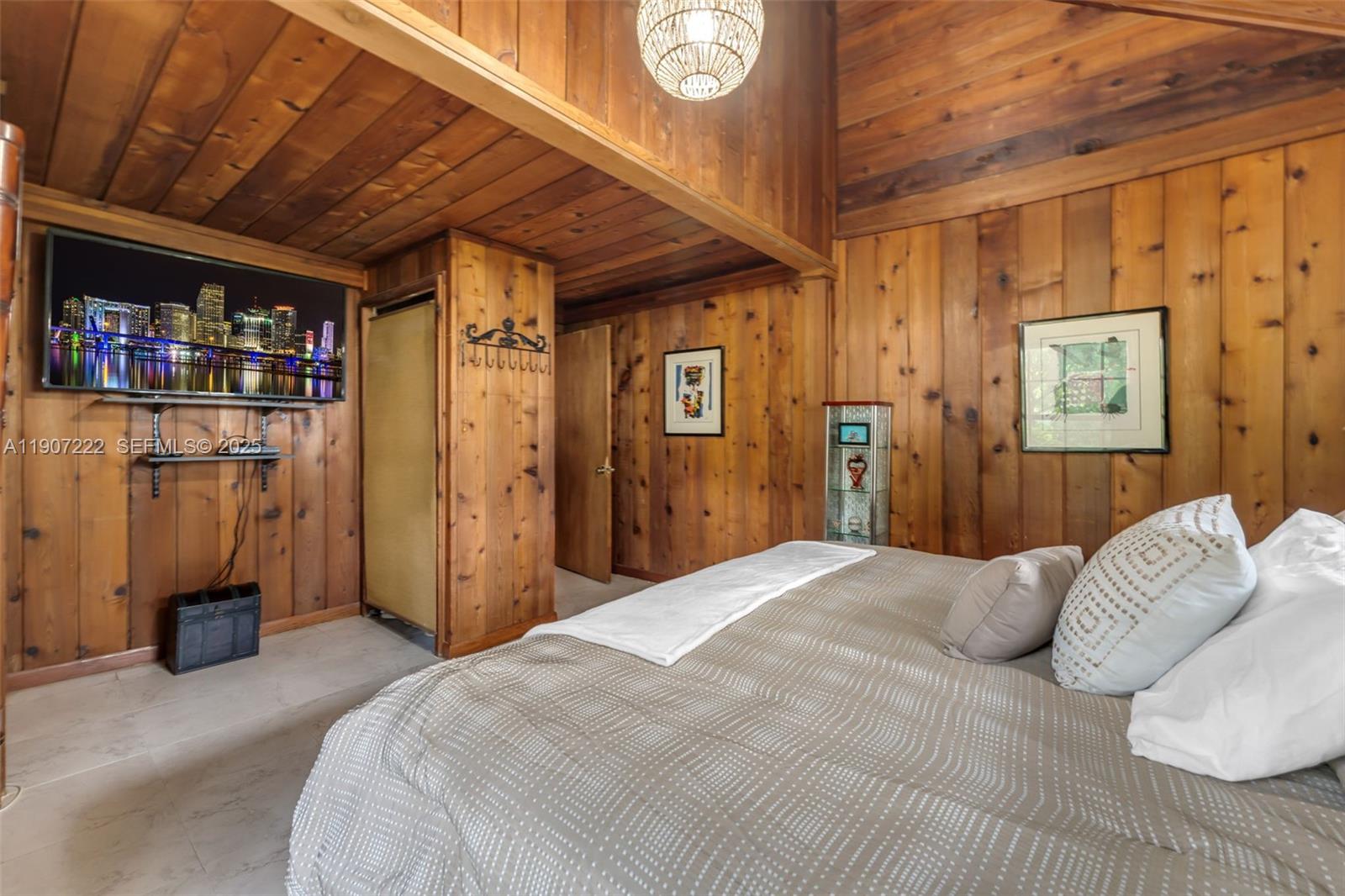 18895 Southwest 212th Street Miami, FL 33187 - Photo 17 of 36 a bedroom with a bed and a book shelf