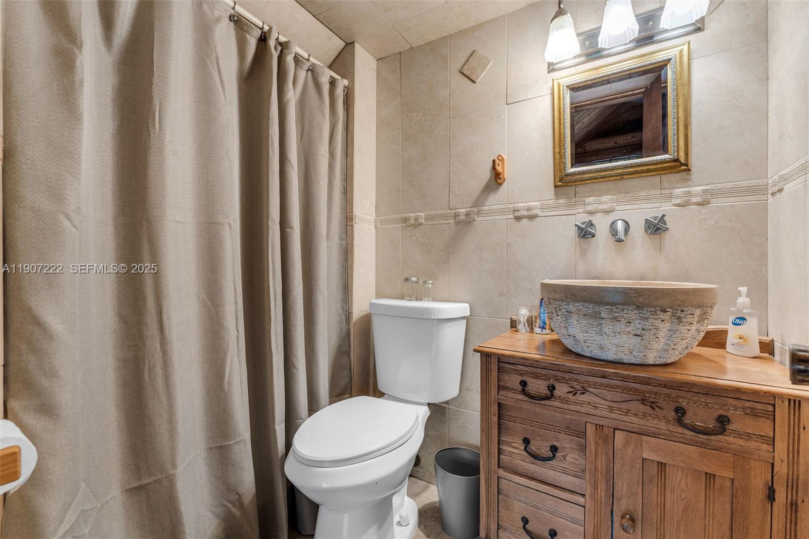 18895 Southwest 212th Street Miami, FL 33187 - Photo 18 of 36 a bathroom with a toilet a sink and a mirror