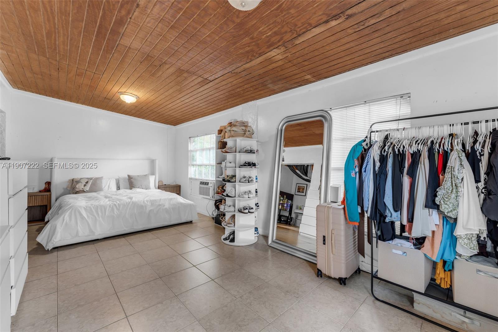 18895 Southwest 212th Street Miami, FL 33187 - Photo 24 of 36 a spacious bedroom with a bed and a walk in closet