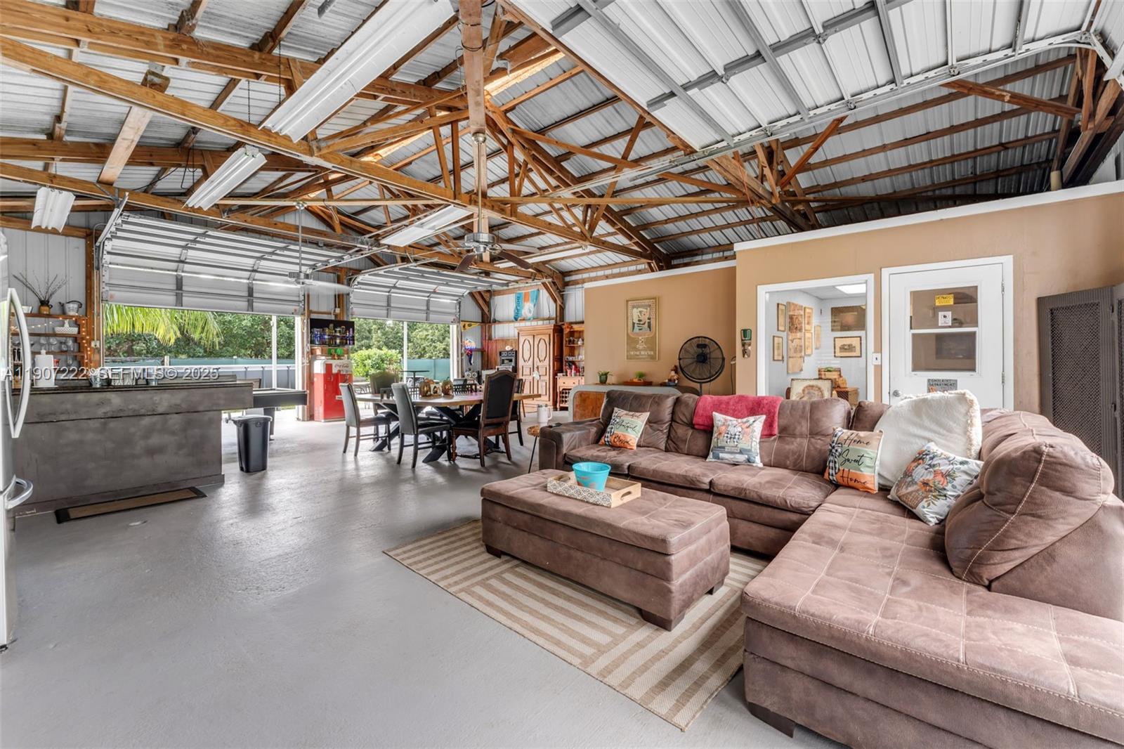 18895 Southwest 212th Street Miami, FL 33187 - Photo 30 of 36 a living room with furniture and a chandelier