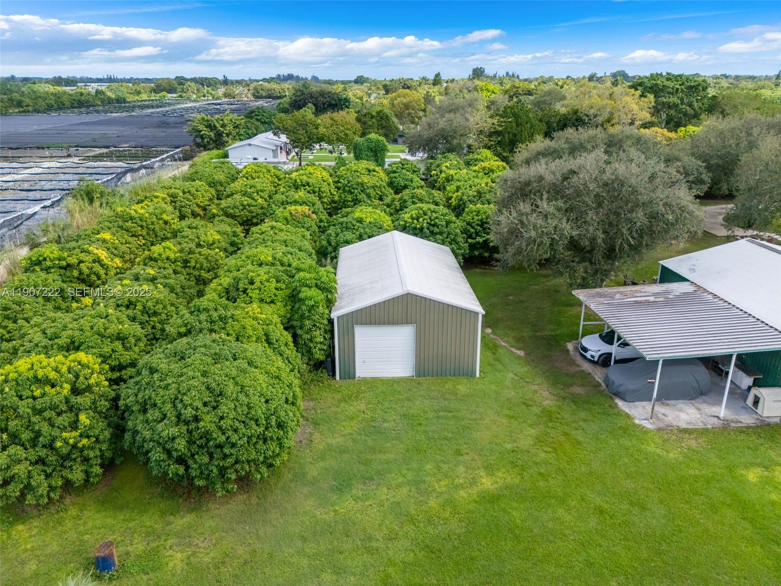 18895 Southwest 212th Street Miami, FL 33187 - Photo 34 of 36 a view of a garden with a lake