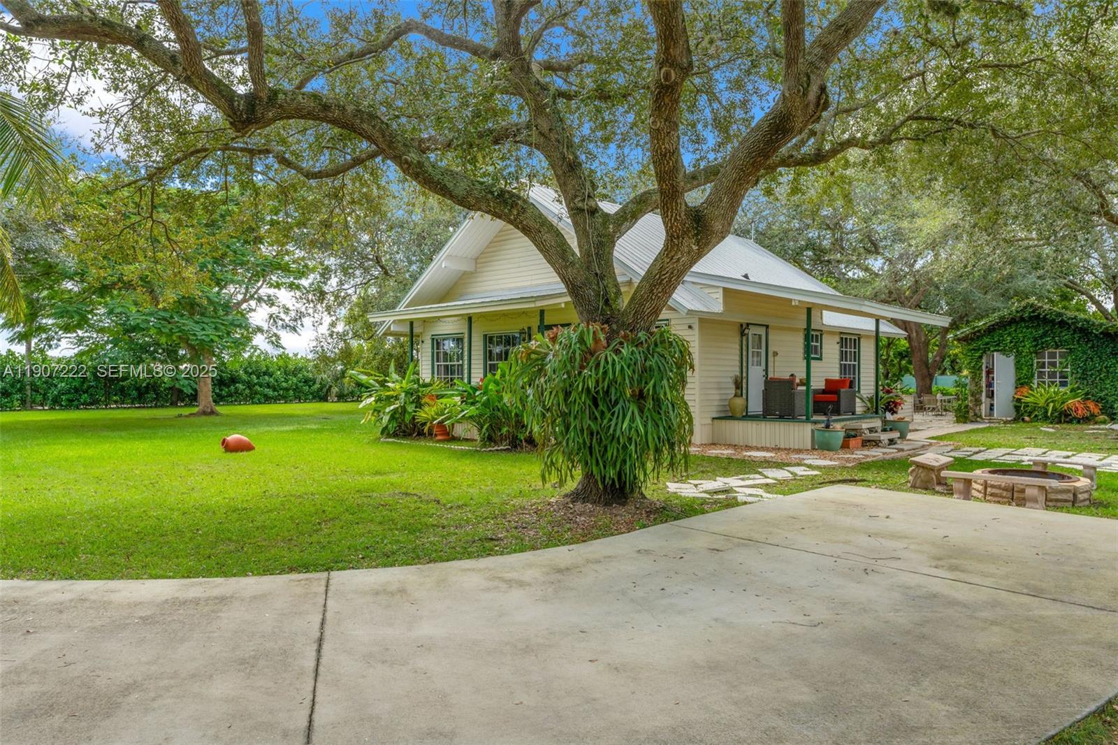 18895 Southwest 212th Street Miami, FL 33187 - Photo 9 of 36 a front view of a house with a yard and trees